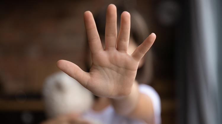 Crop close up of little girl child stretch hand show no gesture protest against domestic violence. Small teen child stand against discrimination or school abuse. Childhood problem, voice concept.