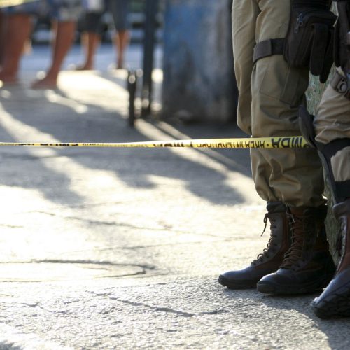salvador, bahia, brazil - october 4, 2016: military police are seen next to the body of a murdered man in the city of Salvador.